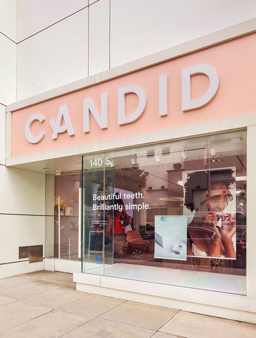 Candid big logo sign over white wall - entrance door and window