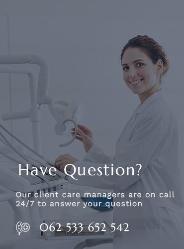 Friendly dental professional smiling next to dental equipment with contact information.