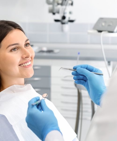 Smiling female patient looking at her dentist during a check-up.
