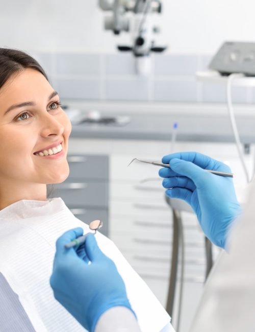 Smiling female patient looking at her dentist during a check-up.